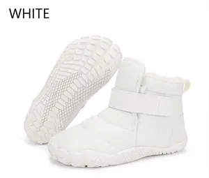 Detailed side view of white waterproof snow boots with hook-and-loop closure and plush lining