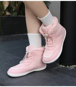 Pink winter snow boot with thick faux fur lining and anti-slip sole shown on a model