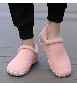 Detail showing pink knitted texture and soft faux fur lining on warm winter slippers