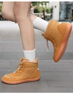 Close-up of waterproof ginger snow boots with thick fleece lining and drawstring toggle