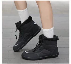 Close-up of black waterproof snow boots with faux fur collar and drawstring toggle