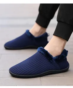 Detail of navy knit winter house slippers with thick plush lining and rubber sole