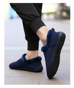 Detail of navy blue knitted slippers with thick plush lining and non-slip rubber sole