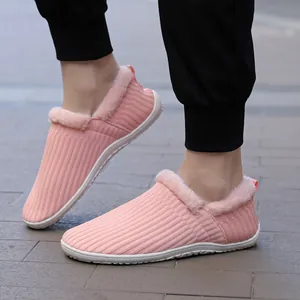 Pink knitted thermal slippers for women featuring thick faux fur lining and non-slip soles