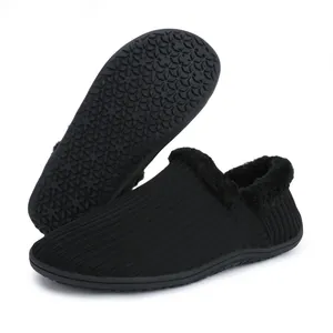 Warm black knitted home slippers with thick faux fur lining and non-slip rubber soles