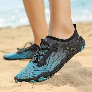 Quick-dry outdoor water shoes in blue and black with non-slip soles on a sandy beach