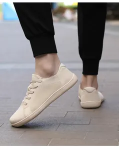 Primer plano de zapatillas de senderismo en malla beige transpirable usadas por un modelo