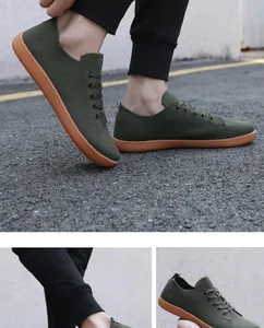 Detail of dark green knit barefoot shoes with brown rubber sole on asphalt ground
