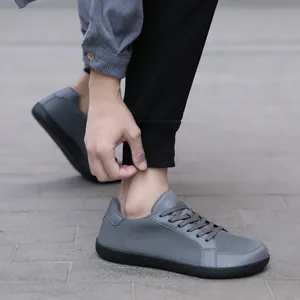Grey barefoot hiking shoes for men with breathable wide-toe design and non-slip rubber soles