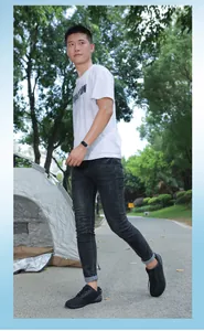Kids barefoot hiking shoes styled with black jeans in an outdoor park setting