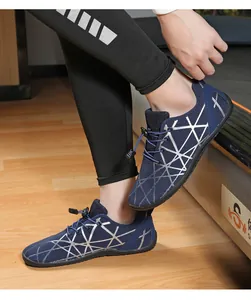 Detail of navy barefoot shoes with silver geometric patterns and elastic toggle laces