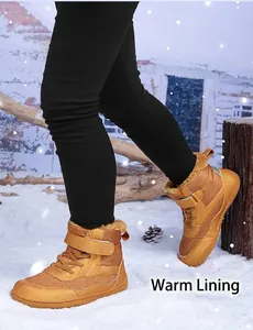 Close-up of children's winter boots featuring warm faux fur lining and anti-slip rubber soles