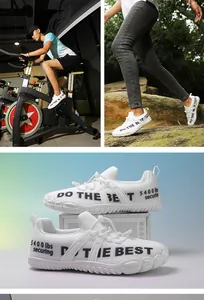 Detail showing white wide toe box sneakers with breathable mesh and black slogan printing
