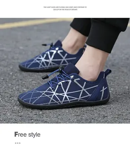 Detailed side view of navy blue barefoot running shoe with quick-lace toggle on asphalt