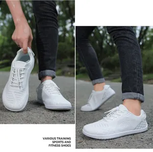 Detail of white barefoot training shoes featuring breathable mesh and drawcord closure