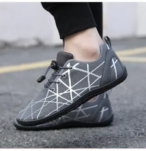 Close-up of grey barefoot shoes with breathable mesh and silver geometric design
