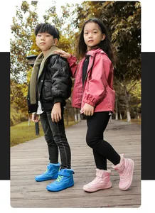 Children outdoors wearing waterproof winter snow boots with warm fleece lining and velcro