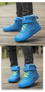 Outdoor shot of blue waterproof kids snow boots with warm fur lining and velcro straps