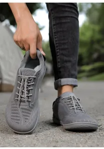 Detail of dark gray barefoot hiking shoe with breathable mesh and elastic toggle laces