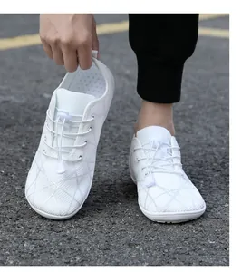 Close-up of white barefoot shoe showing flexible sole and breathable mesh fabric