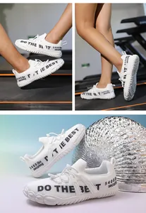 Macro shot of white wide-toe sneakers featuring Do The Best text and textured sole details