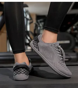 Detailed side view of gray barefoot running shoes on a gym treadmill for kids