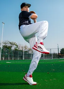 Low-angle shot of professional soccer shoes with dynamic white and red flame design detail