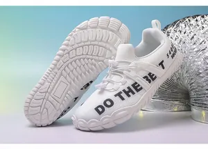 Detail of white wide-toe hiking shoes with non-slip rubber soles and breathable mesh upper