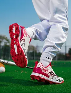 Macro view of white and red high-quality soccer cleat studs on grass sports field