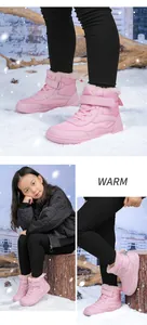 Detail of pink girls winter boots with plaid fabric, warm faux fur collar and strap