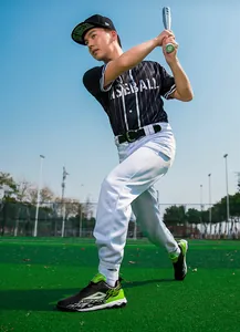 Outdoor athlete in professional baseball gear and cleats holding a silver metal bat