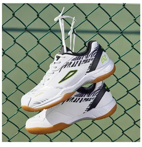 Dettaglio scarpe da badminton bianche con suola in gomma appese a una recinzione