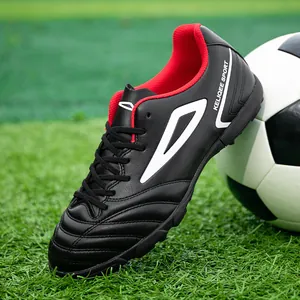 High-quality black synthetic leather soccer cleats on green turf for men and students