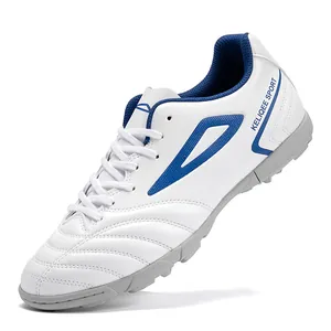 White high-quality men's turf soccer shoes with blue geometric patterns and rubber cleats