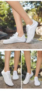 Outdoor white quick-dry water shoes with elastic laces and breathable mesh on river rocks