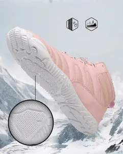 Detailed macro view of pink waterproof snow boots with thick anti-slip rubber soles