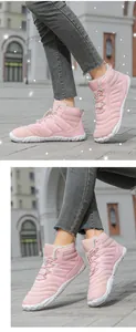 Detail of pink winter snow boots showing quilted waterproof fabric and plush faux fur lining