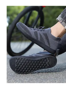 Detail of grey barefoot training shoes with breathable knit upper and hex-grip rubber sole