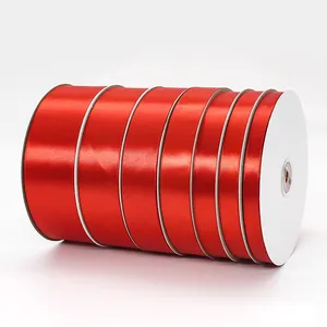 Roll of vibrant red satin ribbon for wedding decoration and luxury gift wrapping
