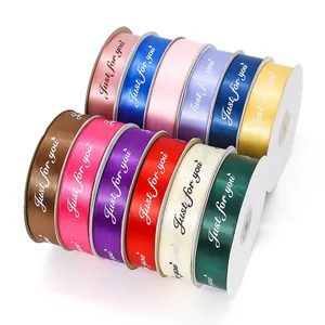 Rolls of colorful satin ribbons with Just for you gold lettering for gift wrapping