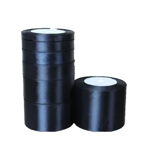 Glossy black satin ribbon rolls in various widths for gift wrapping and DIY crafts
