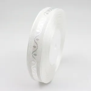Close-up of white chiffon ribbon with grey wave pattern for gift packaging and DIY