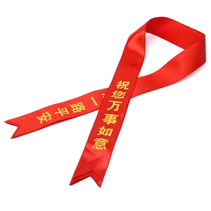 Red satin ceremony sash with gold inscriptions and swallowtail ends for car delivery