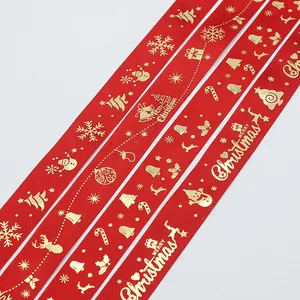 Red Christmas ribbon with gold Merry Christmas print and festive holiday patterns