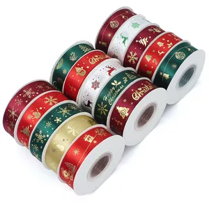 Multiple rolls of Christmas satin ribbons with festive gold snowflake and elk patterns