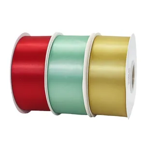 Rolls of 4.8cm high-density polyester satin ribbons in red, green, and champagne gold