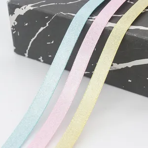 Satin ribbons in blue, pink, and yellow for gift boxes and decorative DIY crafts