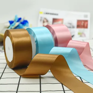 Satin ribbon in bronze, light blue and pink for gift wrapping and DIY crafts
