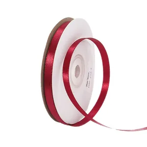 Single roll of 6mm wide red double-sided satin ribbon for gift wrapping and hair styling