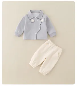 Detail of baby cotton set featuring elephant embroidery and soft ribbed cuffs for comfort